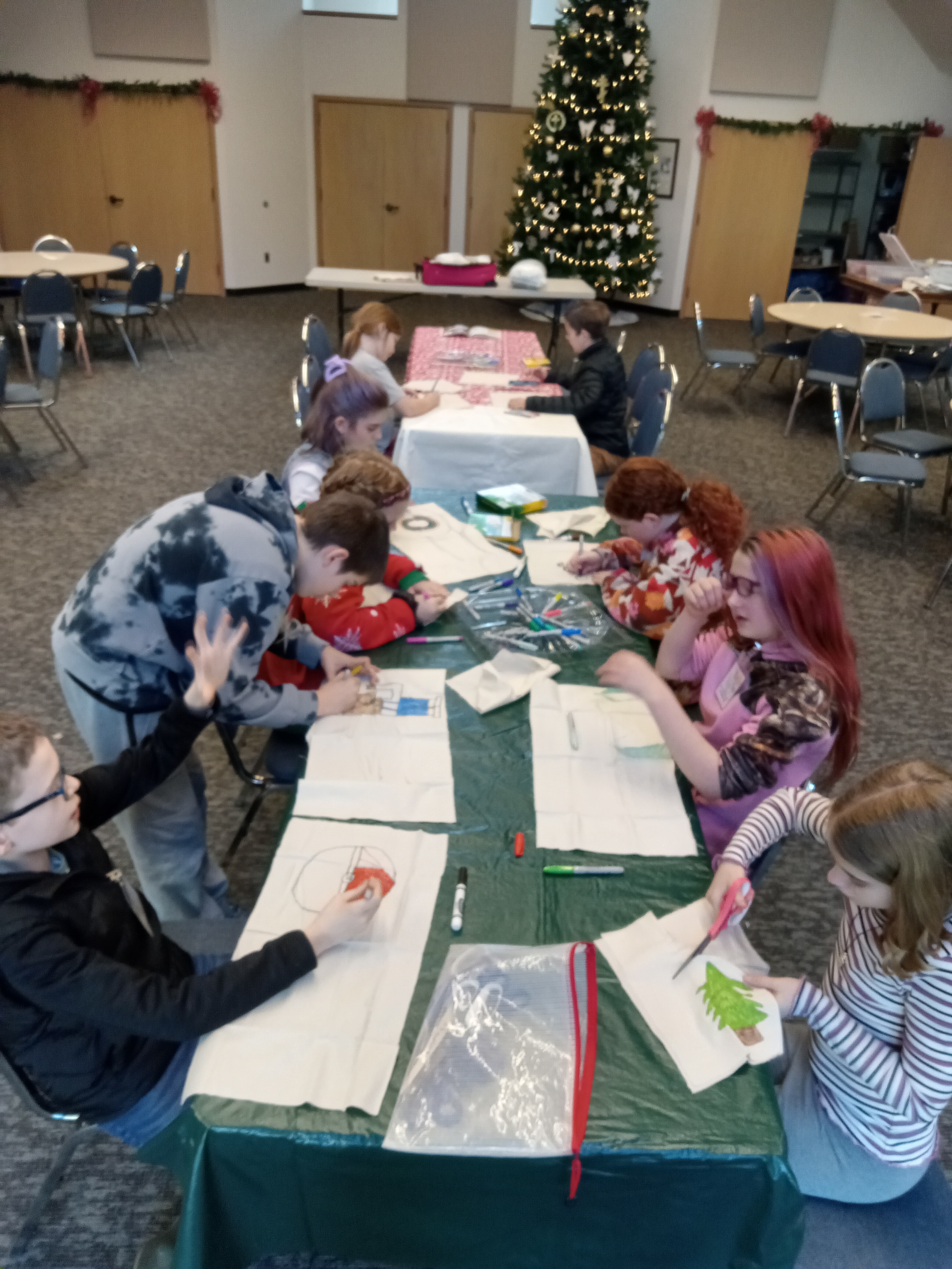 NKHC children making art together around a classroom table
